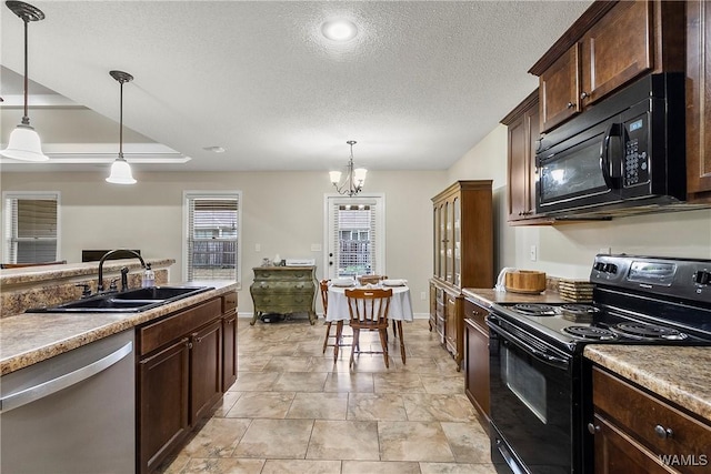 kitchen featuring a textured ceiling, a sink, dark brown cabinets, black appliances, and pendant lighting