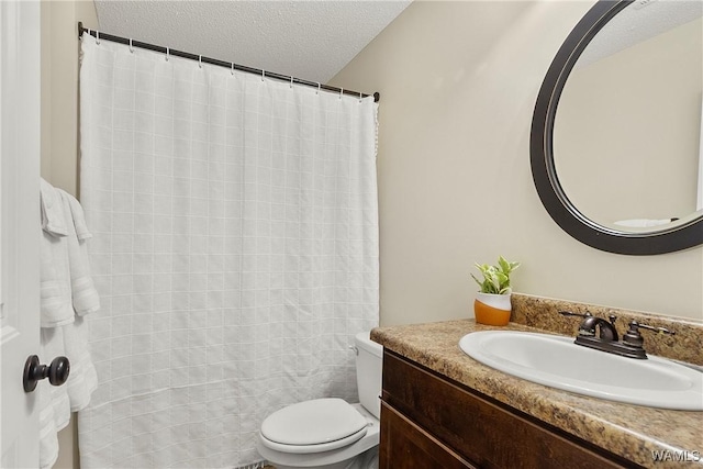 full bath featuring toilet, a textured ceiling, and vanity