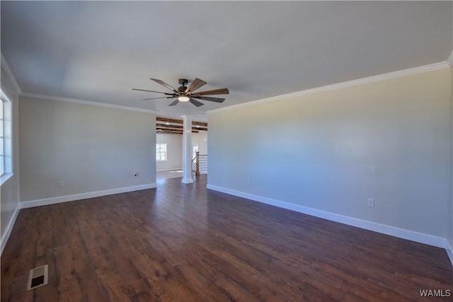 spare room featuring ceiling fan, dark wood-style flooring, visible vents, and crown molding