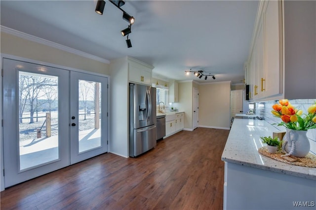 kitchen featuring stainless steel appliances, white cabinetry, french doors, decorative backsplash, and crown molding