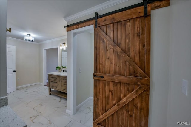 bathroom featuring marble finish floor, baseboards, crown molding, and vanity