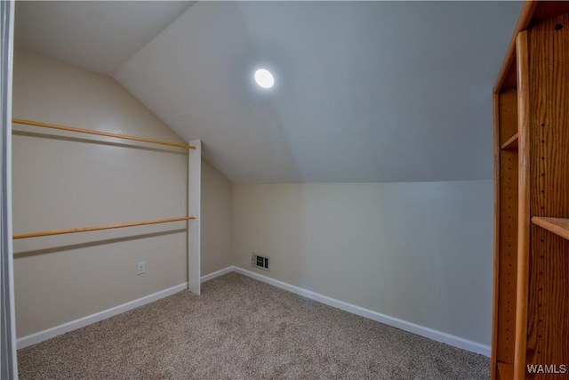 bonus room featuring carpet floors, visible vents, vaulted ceiling, and baseboards