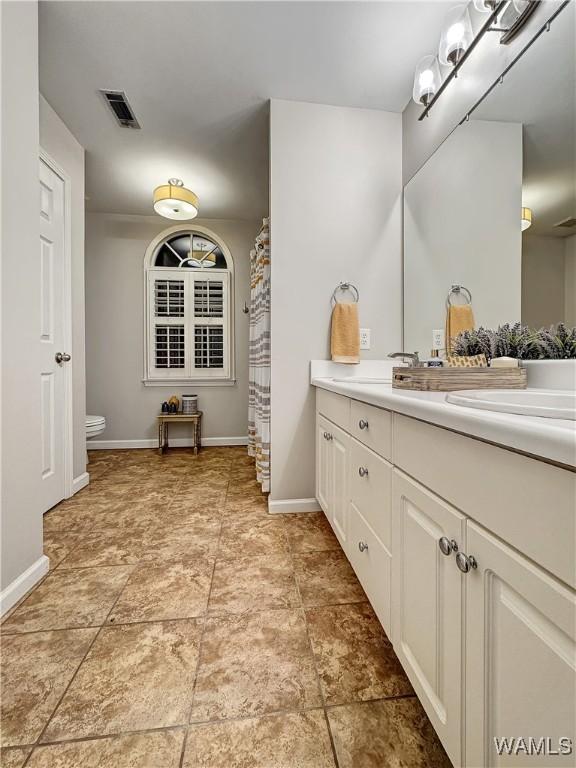 bathroom with vanity and toilet