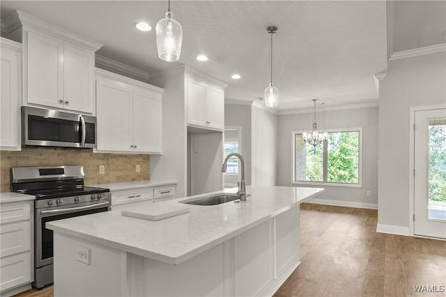 kitchen with white cabinets, sink, an island with sink, and appliances with stainless steel finishes