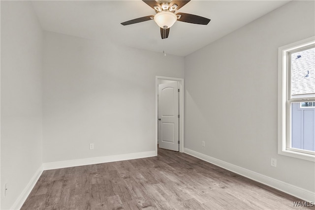 spare room with ceiling fan and light wood-type flooring