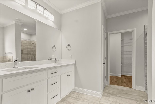 bathroom with wood-type flooring, vanity, a shower with door, and crown molding