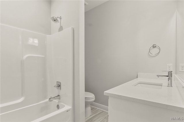 full bathroom with hardwood / wood-style flooring, vanity, toilet, and tub / shower combination