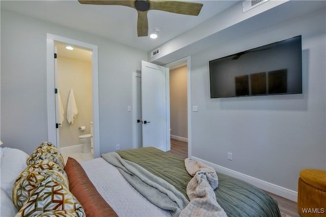 bedroom featuring ceiling fan, ensuite bath, visible vents, and baseboards