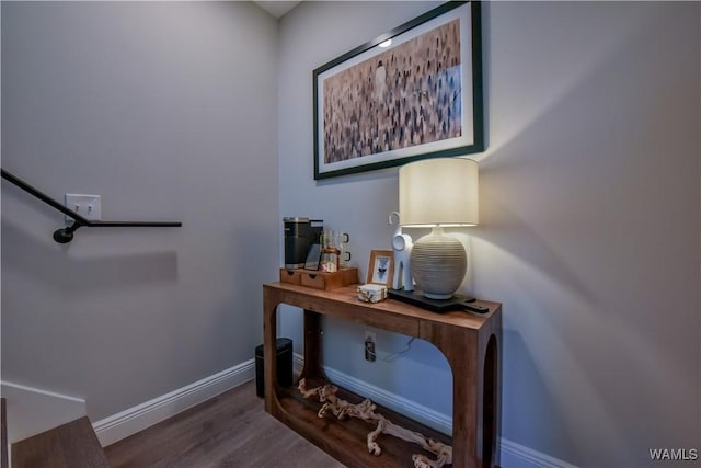 interior space featuring baseboards and dark wood-type flooring