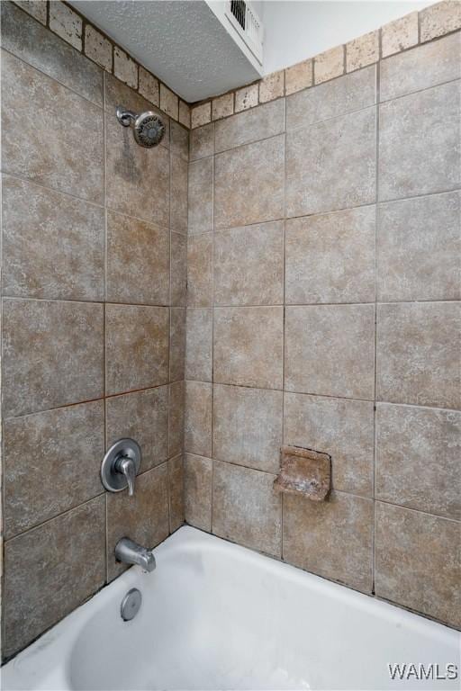 interior details with shower / bath combination and visible vents