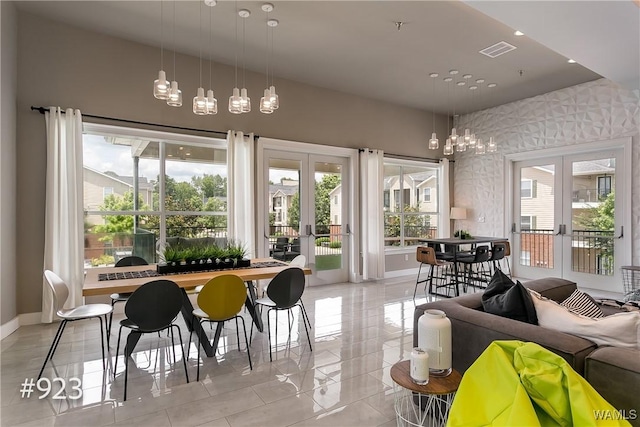 dining area featuring french doors, visible vents, a wealth of natural light, and baseboards