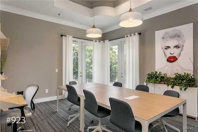 carpeted office space with visible vents, baseboards, a tray ceiling, ornamental molding, and french doors