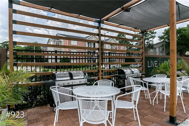 view of patio with area for grilling and outdoor dining area