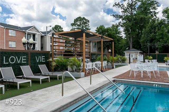 community pool with a patio and fence