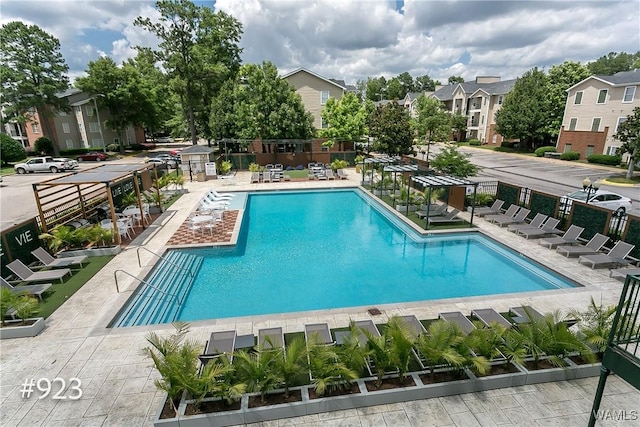 community pool featuring a patio area and fence