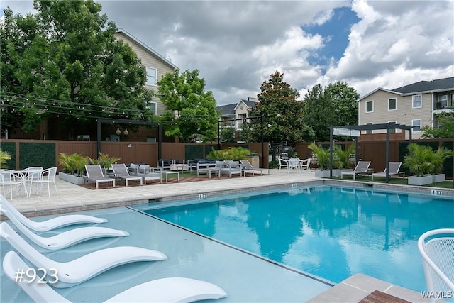 pool featuring a patio, a pergola, and fence