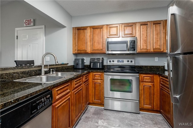 kitchen with brown cabinets, stainless steel appliances, and a sink