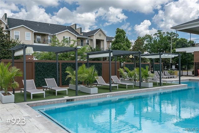 pool featuring a patio, fence, and a pergola