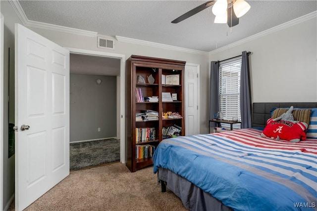 bedroom with visible vents, carpet, ornamental molding, and a textured ceiling