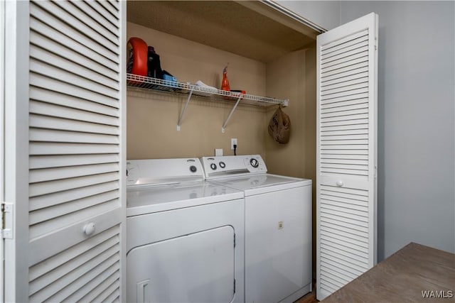 laundry area featuring separate washer and dryer and laundry area