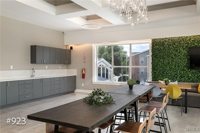 dining room with baseboards, coffered ceiling, and an inviting chandelier