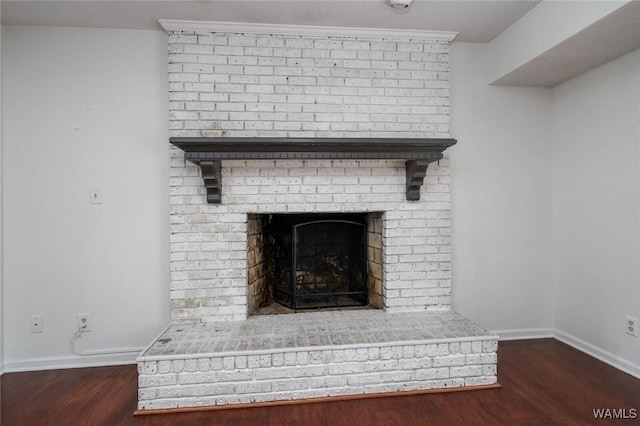4410 Nicholas Ave, Northport, AL 35473 - detailed view of wood finished floors and a brick fireplace