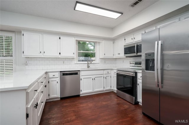 4410 Nicholas Ave, Northport, AL 35473 - kitchen with stainless steel appliances, tasteful backsplash, light countertops, and white cabinetry