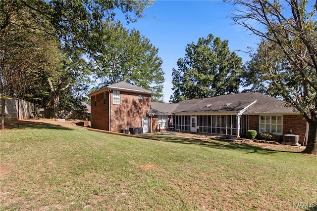 view of yard with a sunroom and central AC