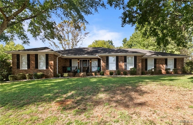 ranch-style house with a porch and a front lawn