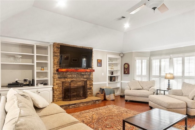 living room with hardwood / wood-style flooring, ceiling fan, high vaulted ceiling, a fireplace, and built in shelves