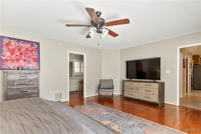 bedroom featuring ensuite bathroom, fridge, dark hardwood / wood-style floors, and ceiling fan