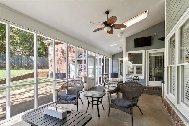 sunroom featuring vaulted ceiling and ceiling fan