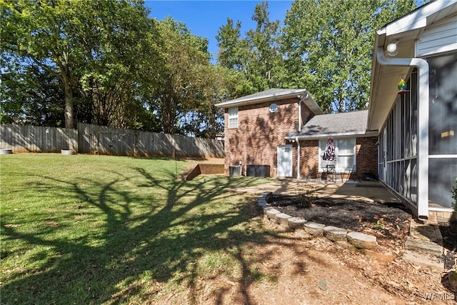 view of yard featuring a patio and a sunroom