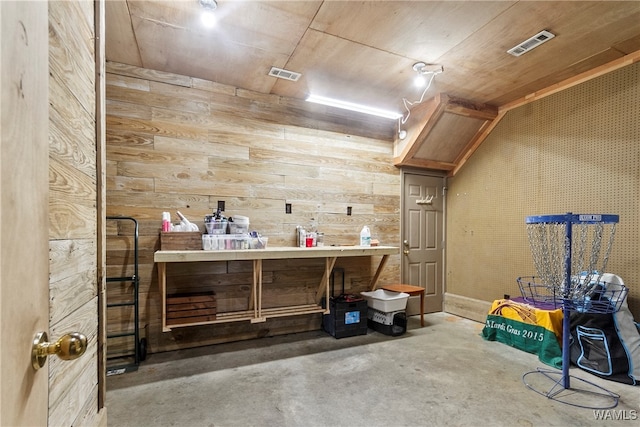 interior space featuring wooden walls and a workshop area