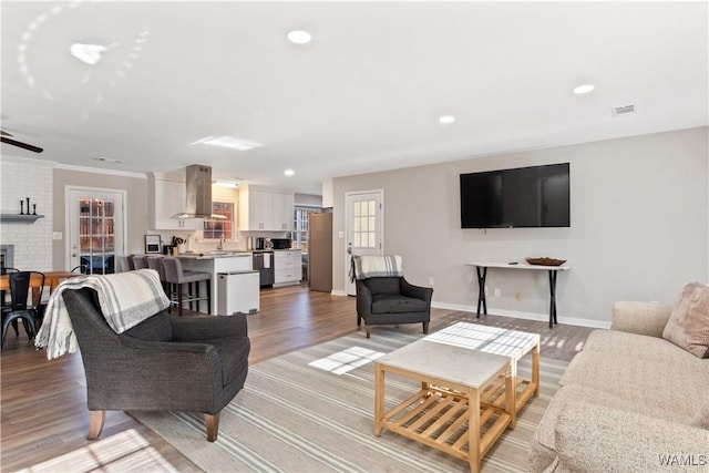 living room featuring ceiling fan and light hardwood / wood-style flooring