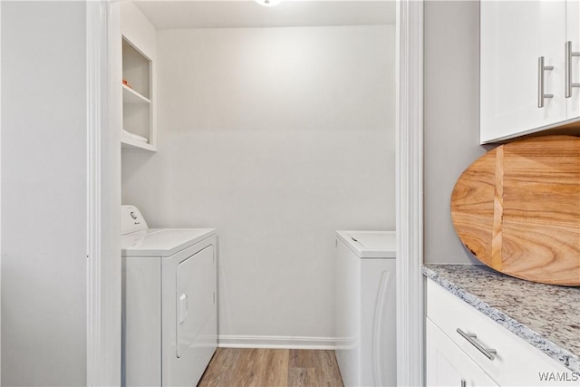 laundry room featuring light wood-type flooring and washing machine and clothes dryer