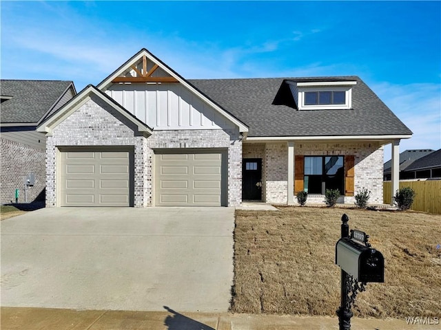 view of front of house with a garage, a front yard, and covered porch