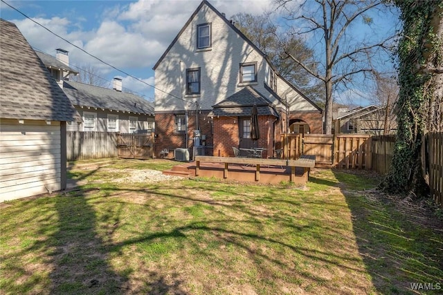 11 Audubon Pl, Tuscaloosa, AL 35401 - rear view of house with roof with shingles, a yard, brick siding, central AC unit, and a fenced backyard