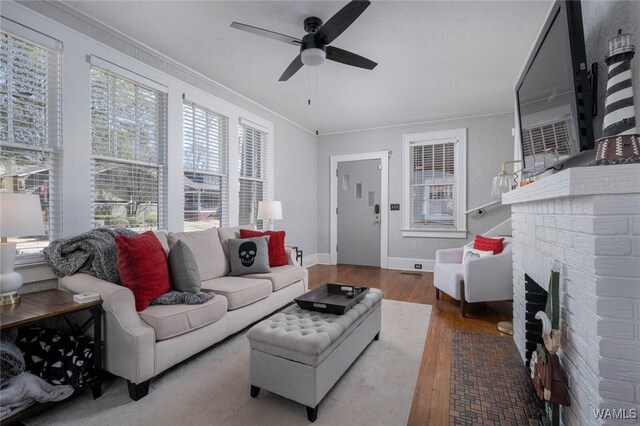 11 Audubon Pl, Tuscaloosa, AL 35401 - living area with baseboards, a ceiling fan, ornamental molding, wood finished floors, and a fireplace