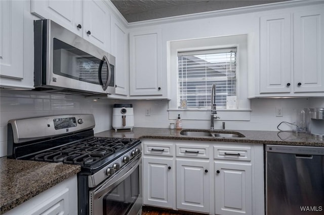11 Audubon Pl, Tuscaloosa, AL 35401 - kitchen with white cabinets, decorative backsplash, stainless steel appliances, and a sink