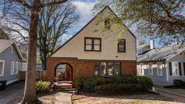 view of front of house with brick siding and stucco siding