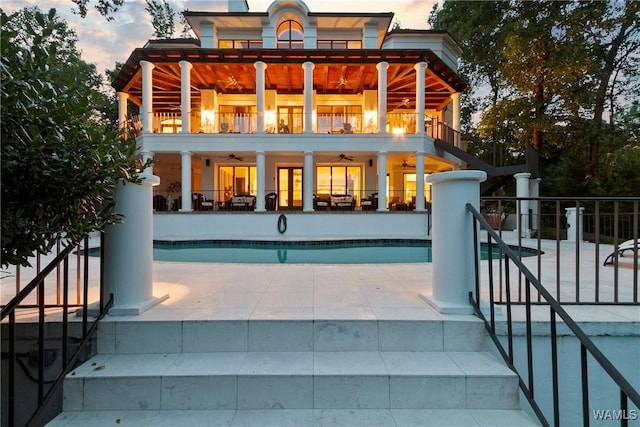 6821 Jade Pt, Tuscaloosa, AL 35406 - back of property at dusk featuring a balcony, ceiling fan, and a patio