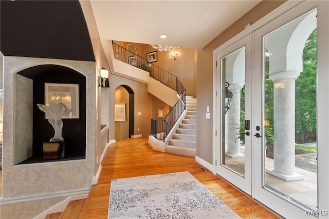 6821 Jade Pt, Tuscaloosa, AL 35406 - entryway featuring stairs, light wood-style flooring, arched walkways, and french doors