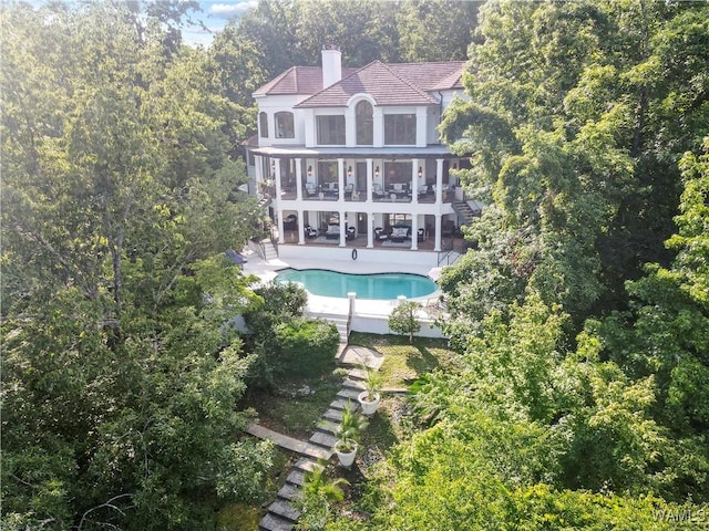 6821 Jade Pt, Tuscaloosa, AL 35406 - rear view of property with stairway, a patio, a balcony, an outdoor pool, and a chimney