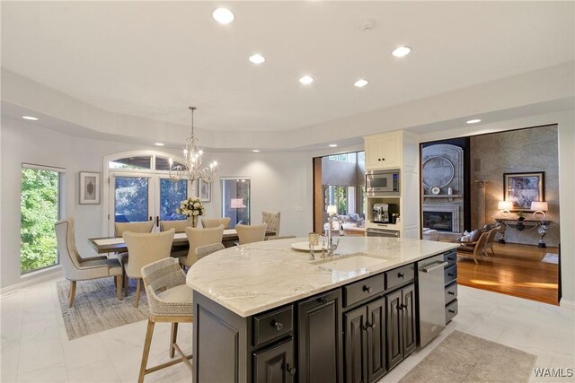 6821 Jade Pt, Tuscaloosa, AL 35406 - kitchen featuring light marble finish flooring, recessed lighting, appliances with stainless steel finishes, light stone counters, and a kitchen island
