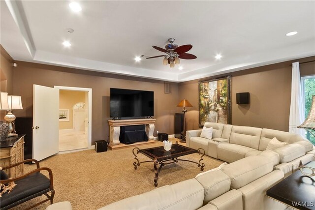 6821 Jade Pt, Tuscaloosa, AL 35406 - carpeted living area with a tray ceiling, ceiling fan, and recessed lighting