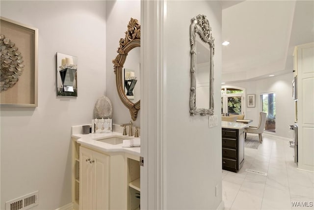 6821 Jade Pt, Tuscaloosa, AL 35406 - bathroom with two vanities, marble look tile flooring, and recessed lighting