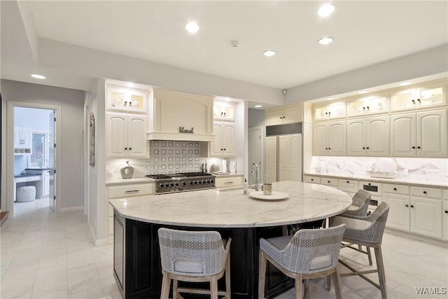 6821 Jade Pt, Tuscaloosa, AL 35406 - kitchen with high quality appliances, recessed lighting, light marble finish floors, glass insert cabinets, and decorative backsplash
