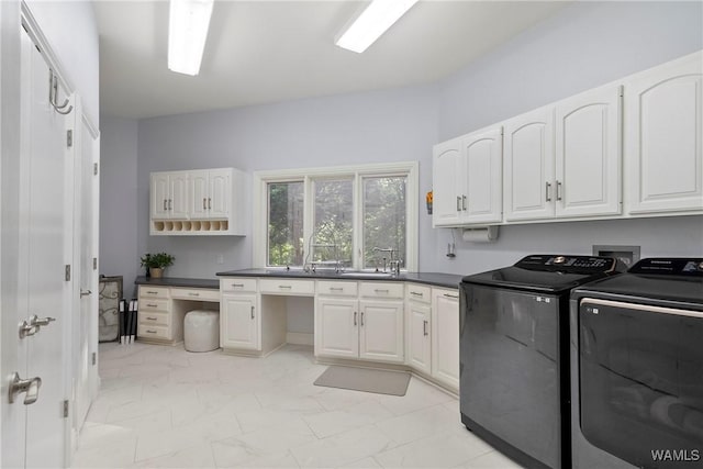 6821 Jade Pt, Tuscaloosa, AL 35406 - washroom featuring separate washer and dryer, cabinet space, and light marble finish flooring