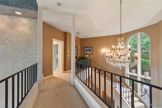 6821 Jade Pt, Tuscaloosa, AL 35406 - hallway with an upstairs landing, carpet floors, and a chandelier